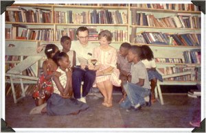 Patti Miller and Marvin Gatch (a Drake graduate) reading to the children in the Community Center in Meridian, Ms. - Freedom Summer '64